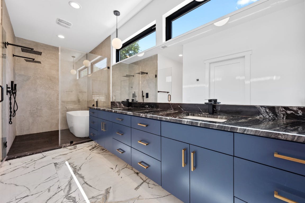 7008 Meador Avenue, Unit 1 Austin, TX 78752 - Photo 15 of 28 a bath room with a sink and a mirror