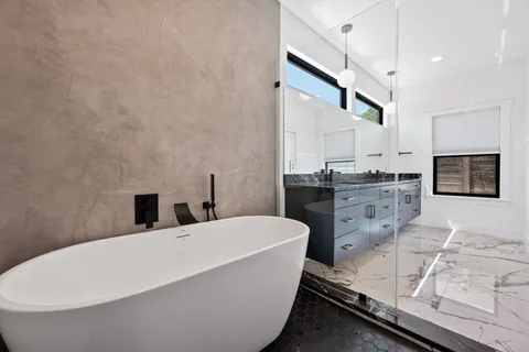 a bathroom with a bathtub and a sink