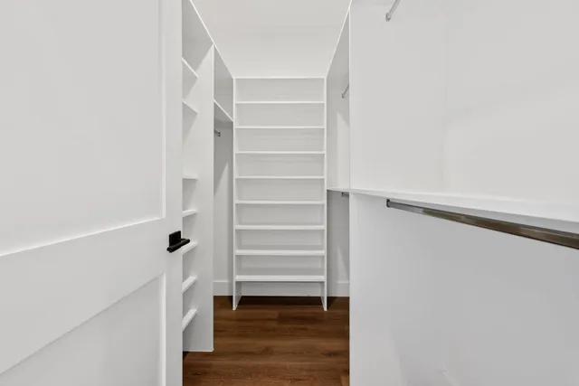 a view of walk in closet with empty racks