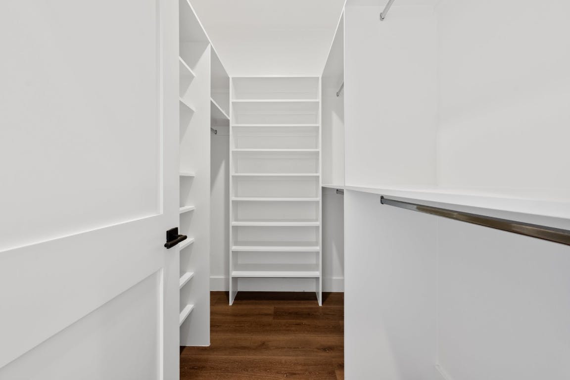 7008 Meador Avenue, Unit 1 Austin, TX 78752 - Photo 18 of 28 a view of walk in closet with empty racks