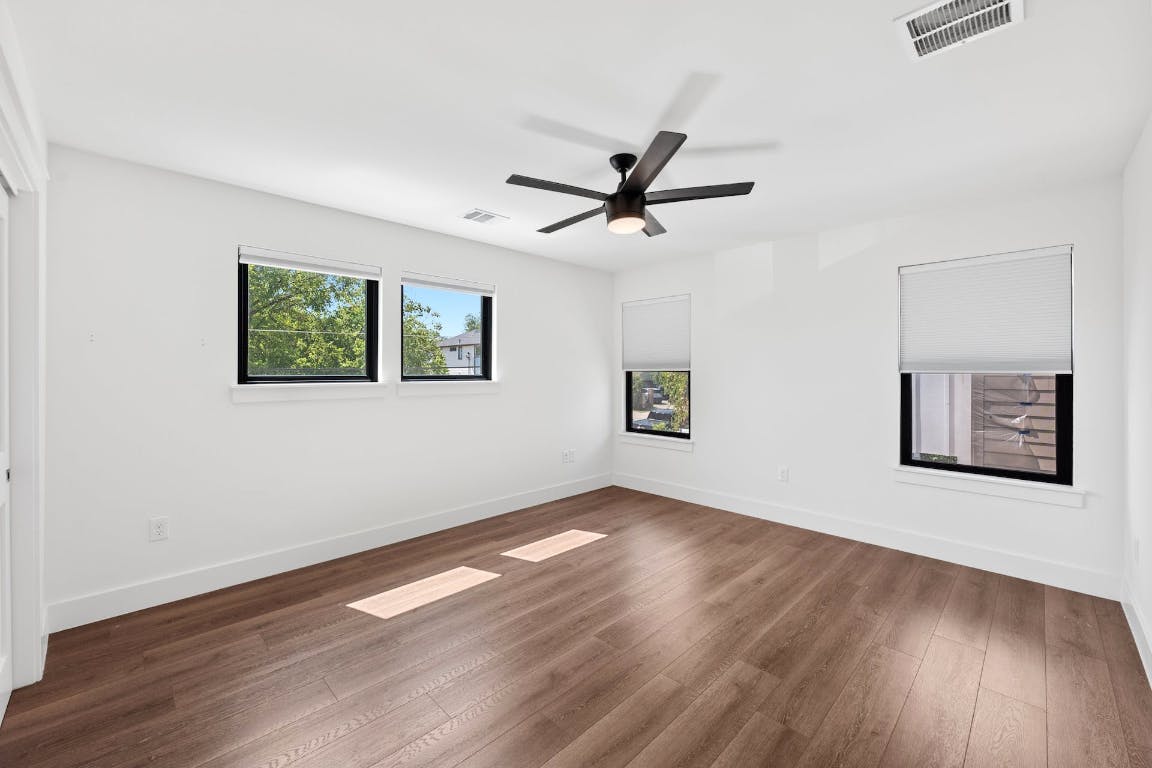 7008 Meador Avenue, Unit 1 Austin, TX 78752 - Photo 22 of 28 a view of a big room with wooden floor and windows