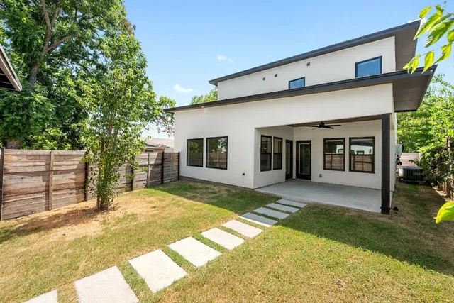 a front view of house with yard and glass windows