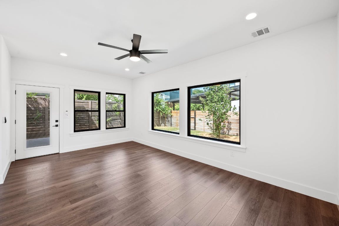 7008 Meador Avenue, Unit 1 Austin, TX 78752 - Photo 10 of 28 a view of an empty room with wooden floor and a window