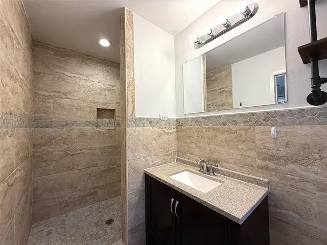 a bathroom with a sink vanity and a mirror