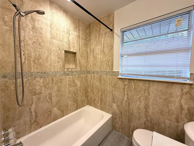 a bathroom with a toilet and shower