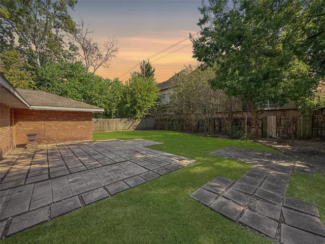 a view of backyard with seating area and green space
