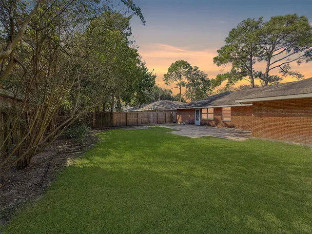 a front view of a house with yard and green space