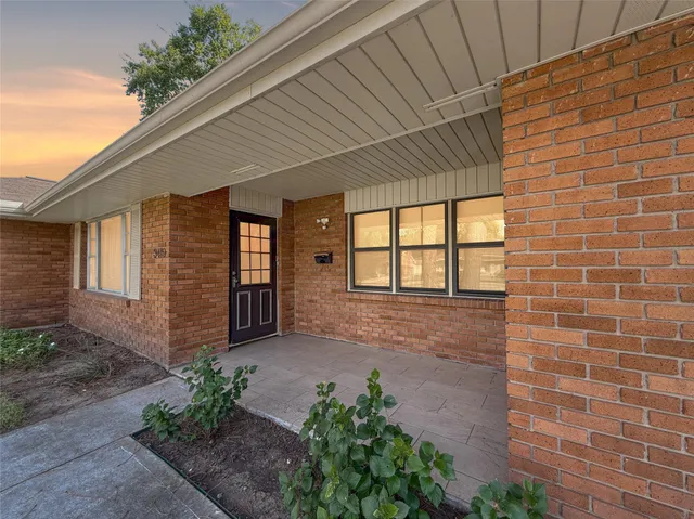 a view of a brick house with a large window