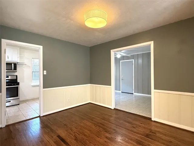 a view of a room with wooden floor and window