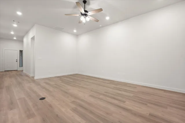 a view of kitchen with microwave and white cabinets
