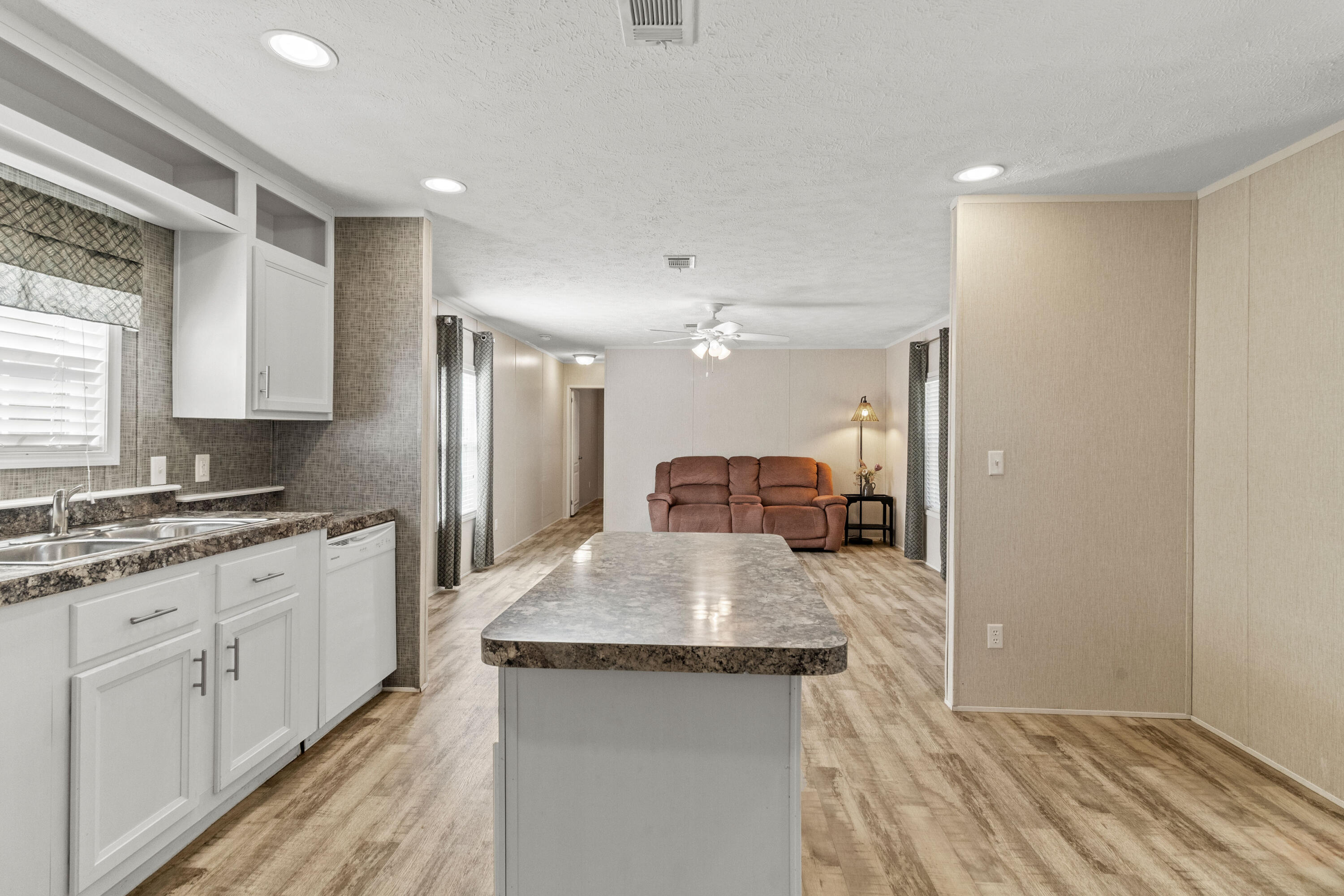 7419 Pappa Lawrence Road Laurel Hill, FL 32567 - Photo 11 of 40 a kitchen with granite countertop a sink stove and refrigerator
