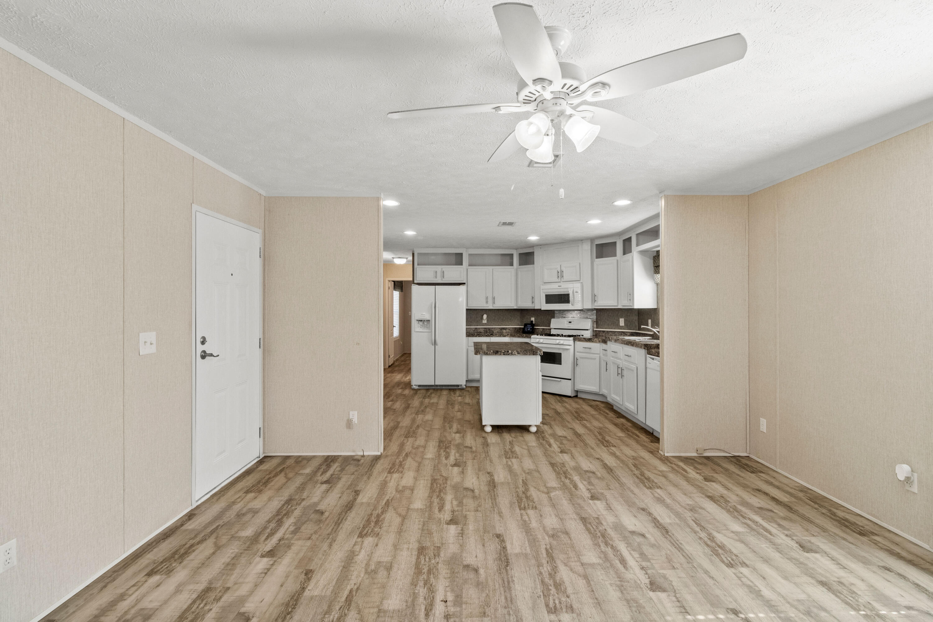 7419 Pappa Lawrence Road Laurel Hill, FL 32567 - Photo 12 of 40 a kitchen with stainless steel appliances a refrigerator and a stove top oven