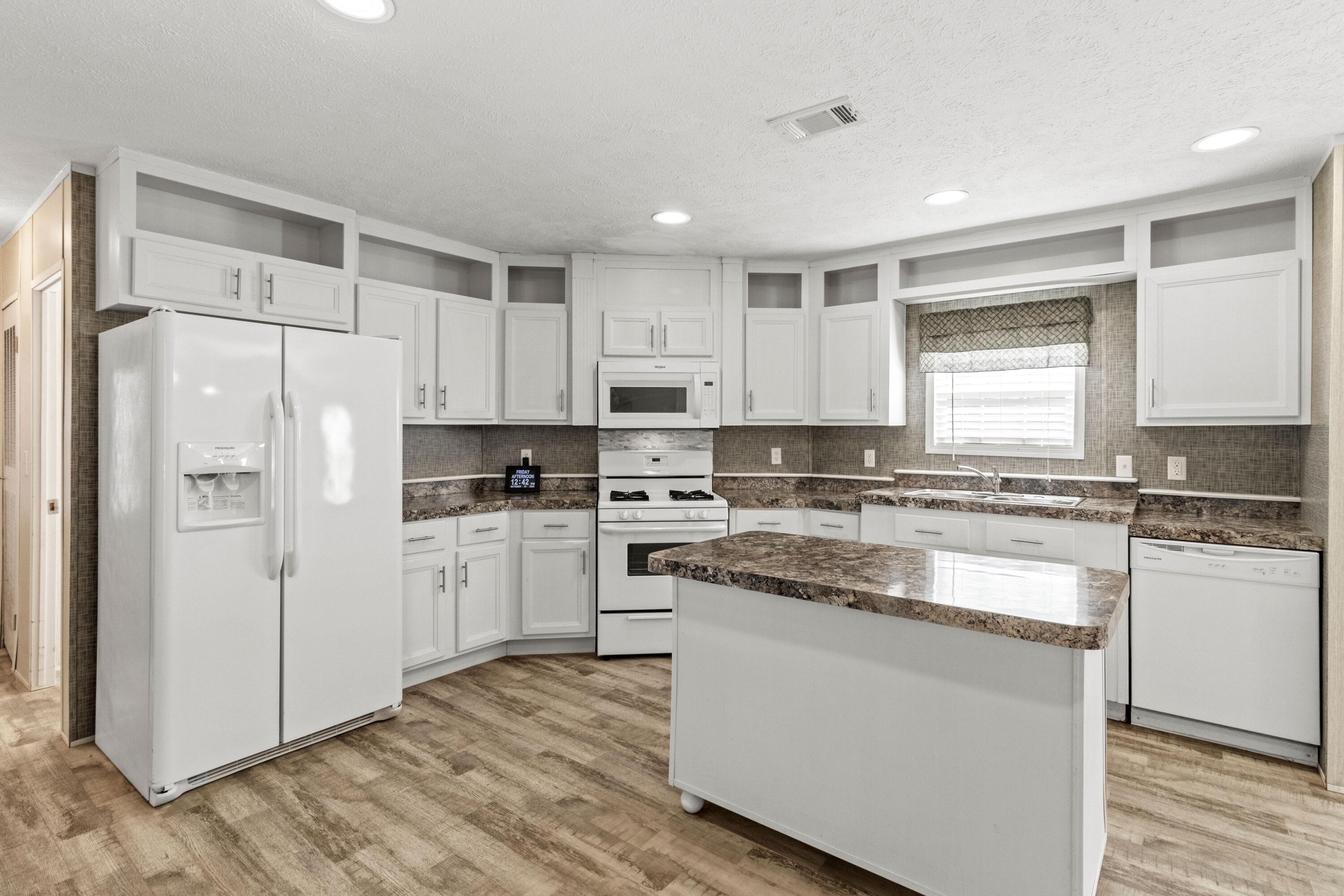 7419 Pappa Lawrence Road Laurel Hill, FL 32567 - Photo 14 of 40 a kitchen with stainless steel appliances granite countertop a refrigerator sink and white cabinets
