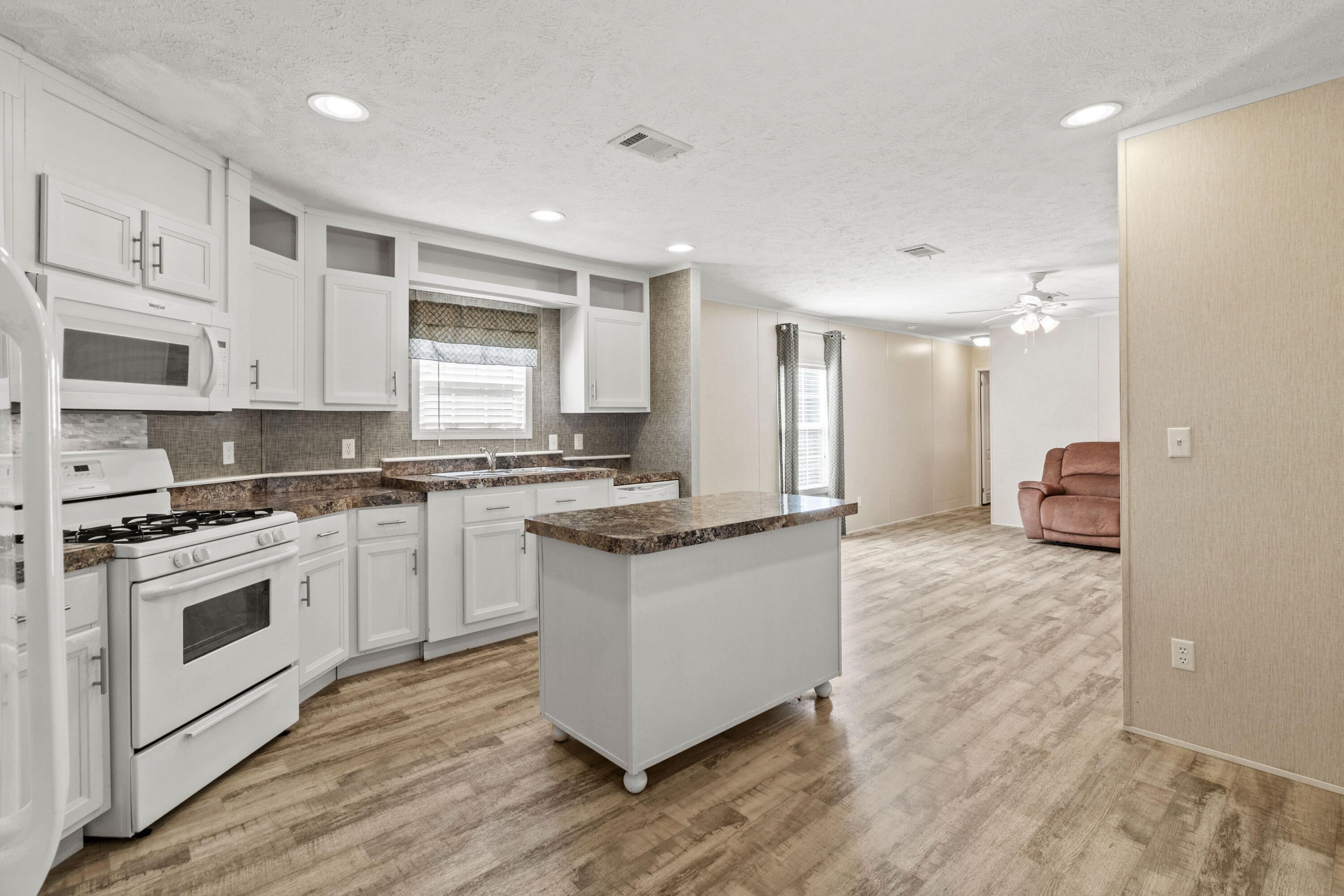 7419 Pappa Lawrence Road Laurel Hill, FL 32567 - Photo 15 of 40 a kitchen with granite countertop a stove top oven sink and cabinets