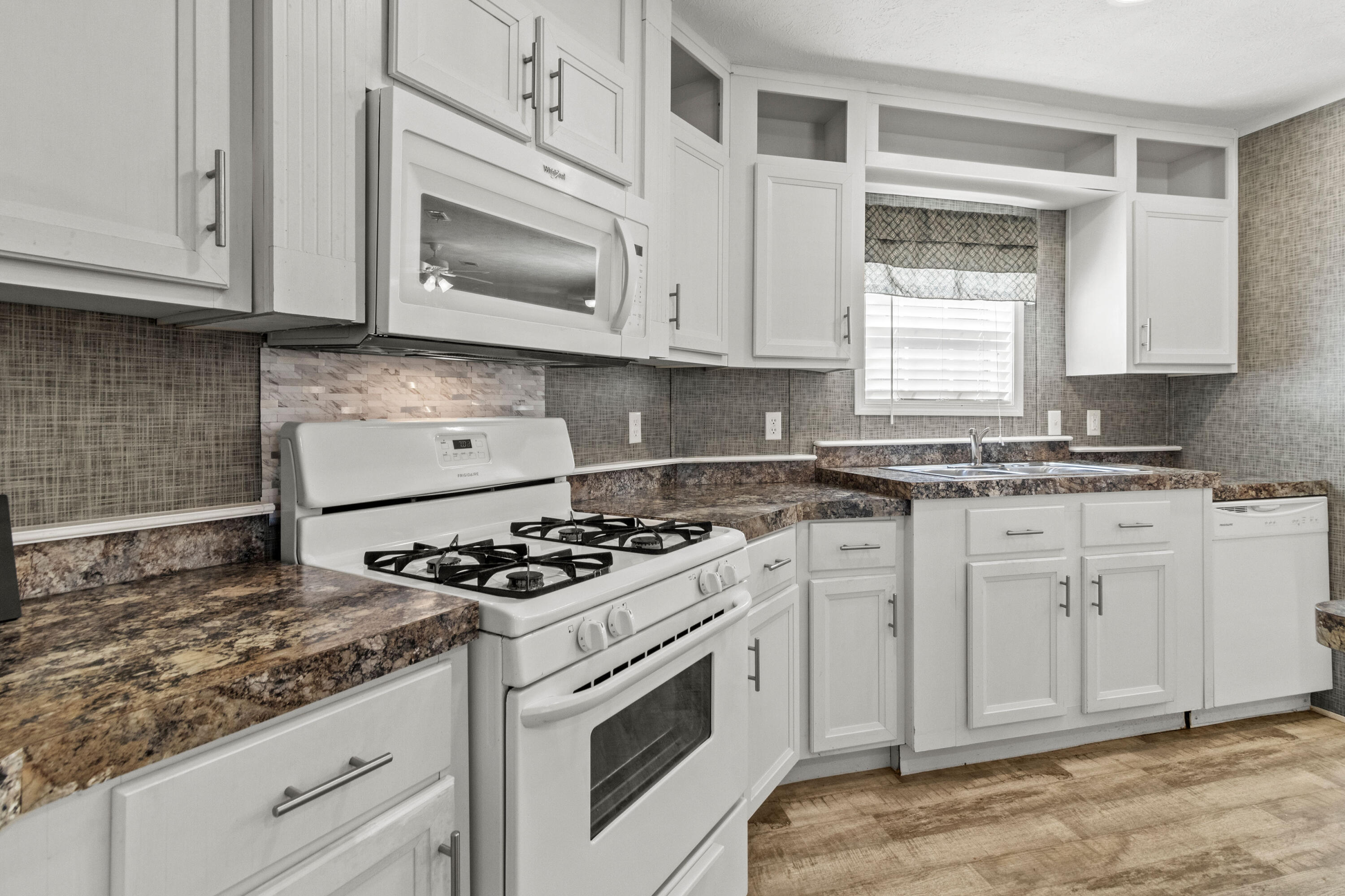 7419 Pappa Lawrence Road Laurel Hill, FL 32567 - Photo 17 of 40 a kitchen with granite countertop cabinets stainless steel appliances and a window