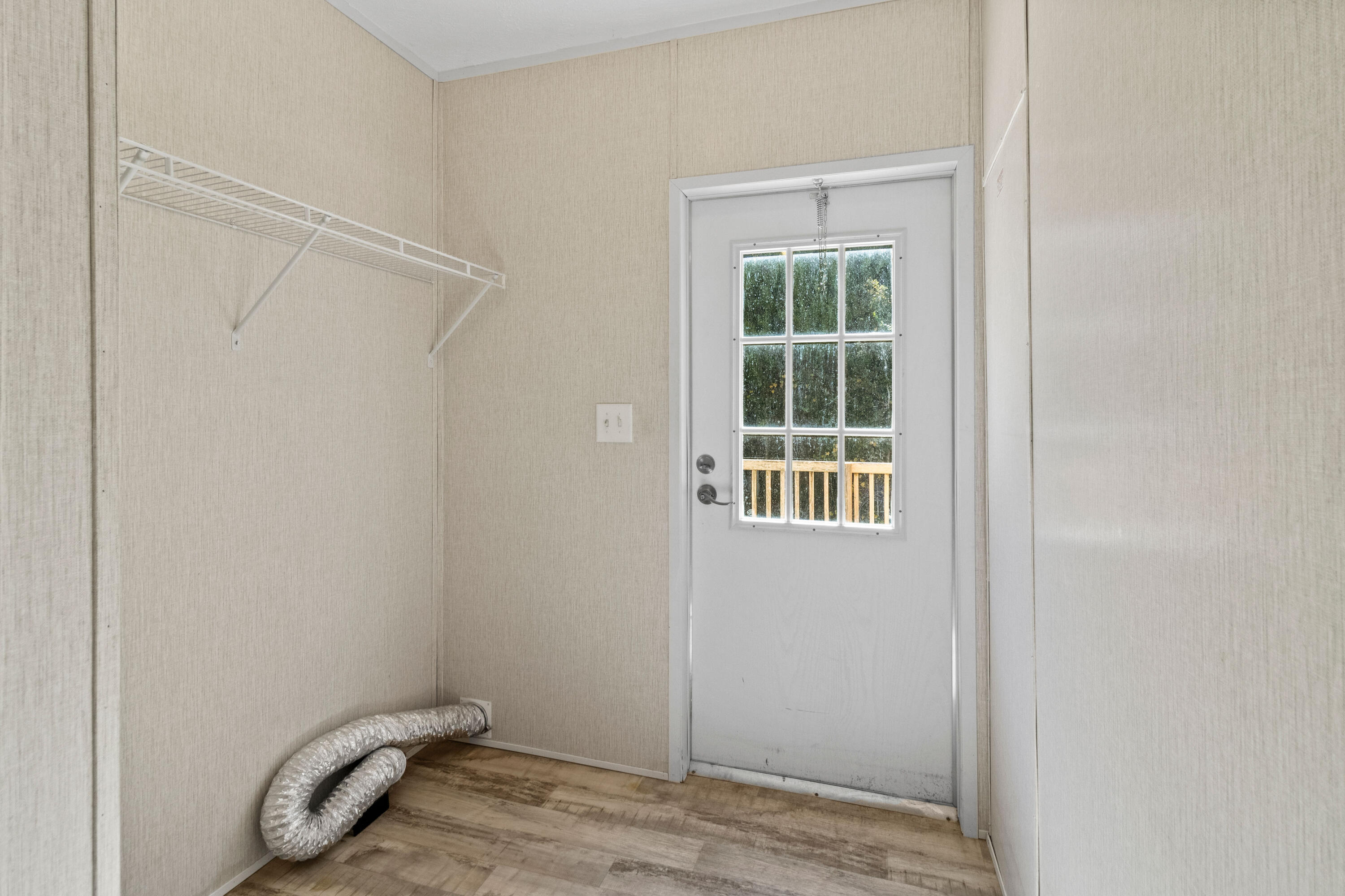 7419 Pappa Lawrence Road Laurel Hill, FL 32567 - Photo 19 of 40 a view of an empty room with wooden floor and a window