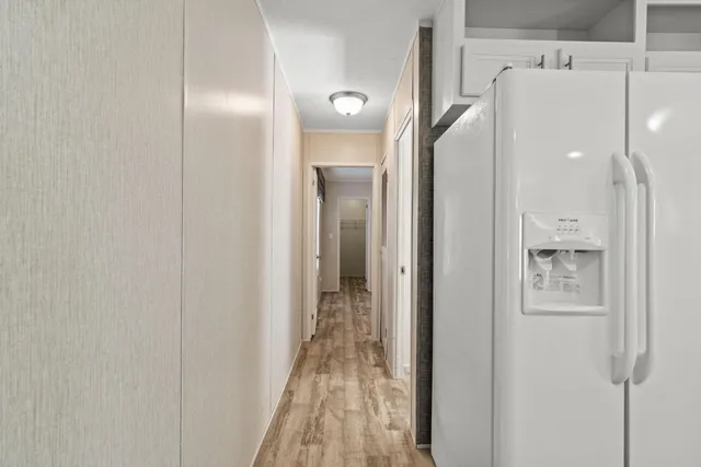 a view of a room with wooden floor and closet area