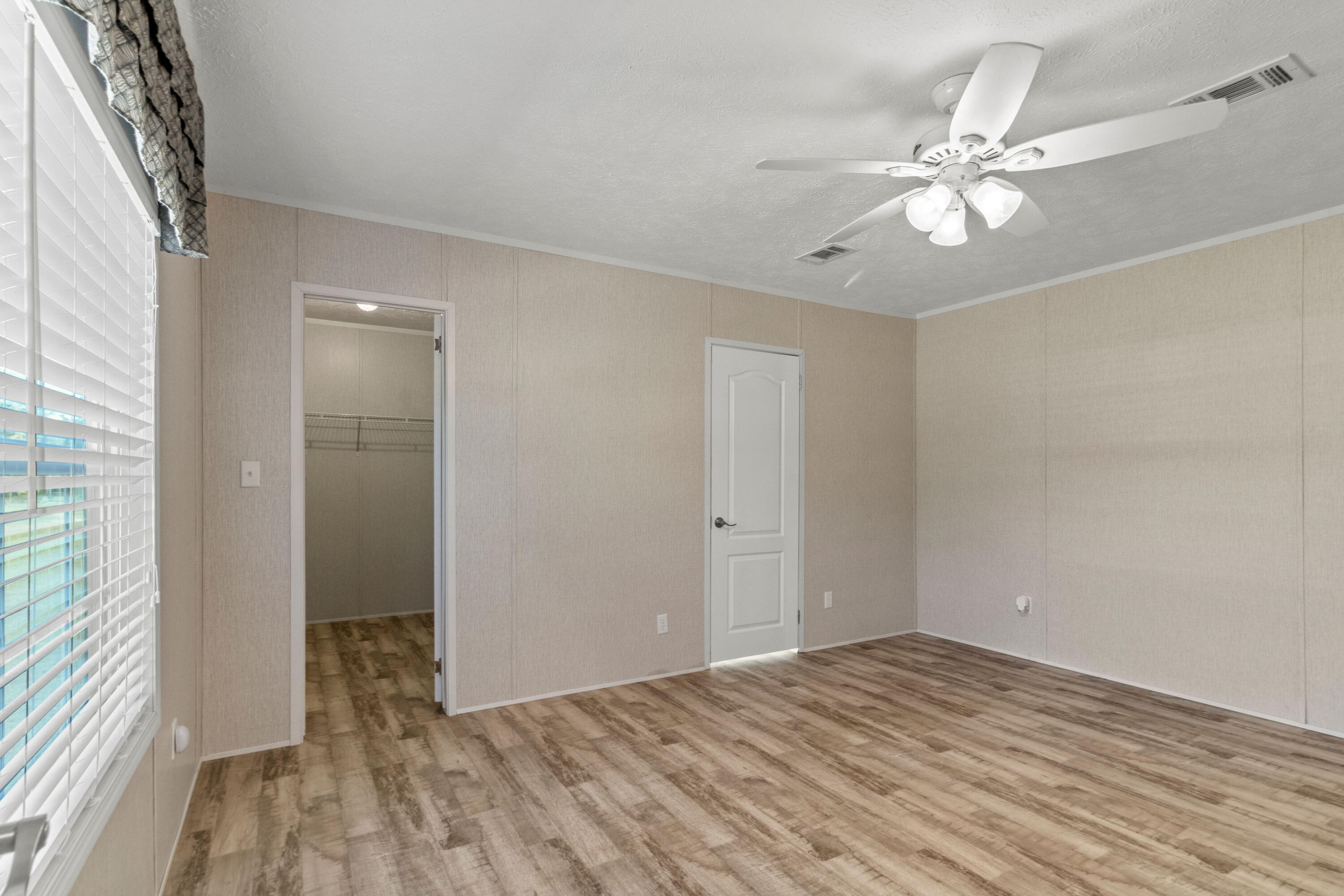 7419 Pappa Lawrence Road Laurel Hill, FL 32567 - Photo 21 of 40 a view of a room with wooden floor and closet area