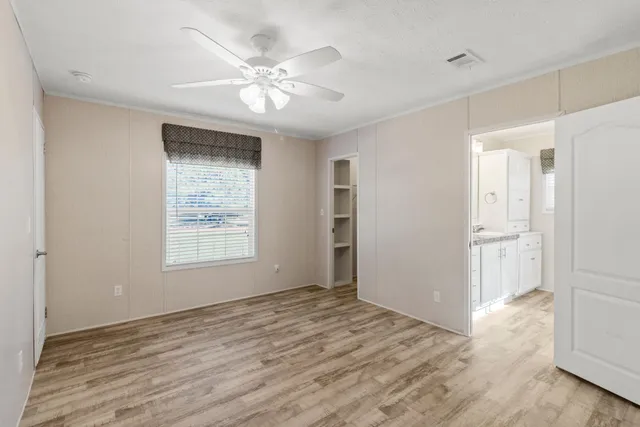 a spacious bathroom with a granite countertop sink a mirror and a shower