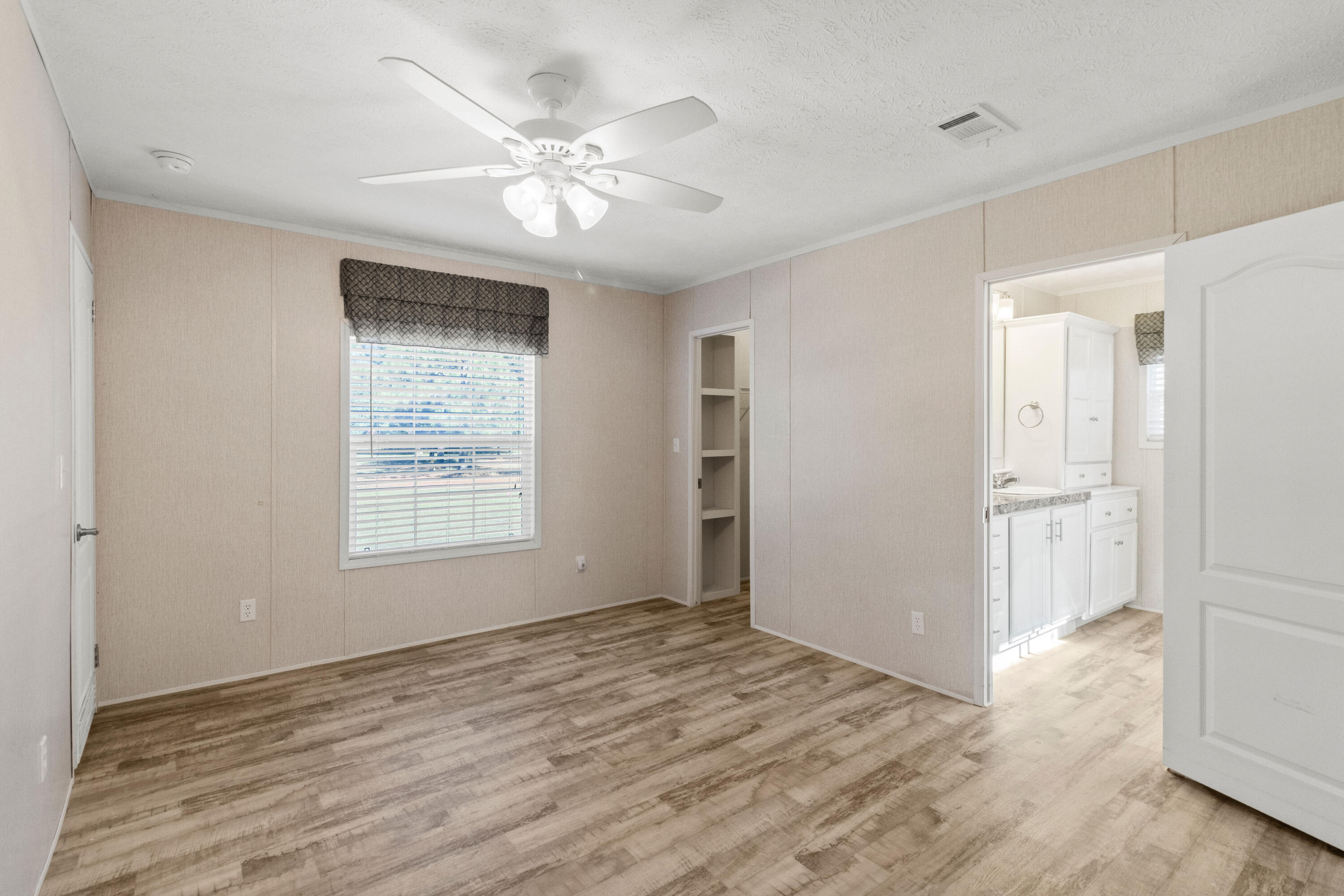7419 Pappa Lawrence Road Laurel Hill, FL 32567 - Photo 24 of 40 a view of an empty room with wooden floor and a window