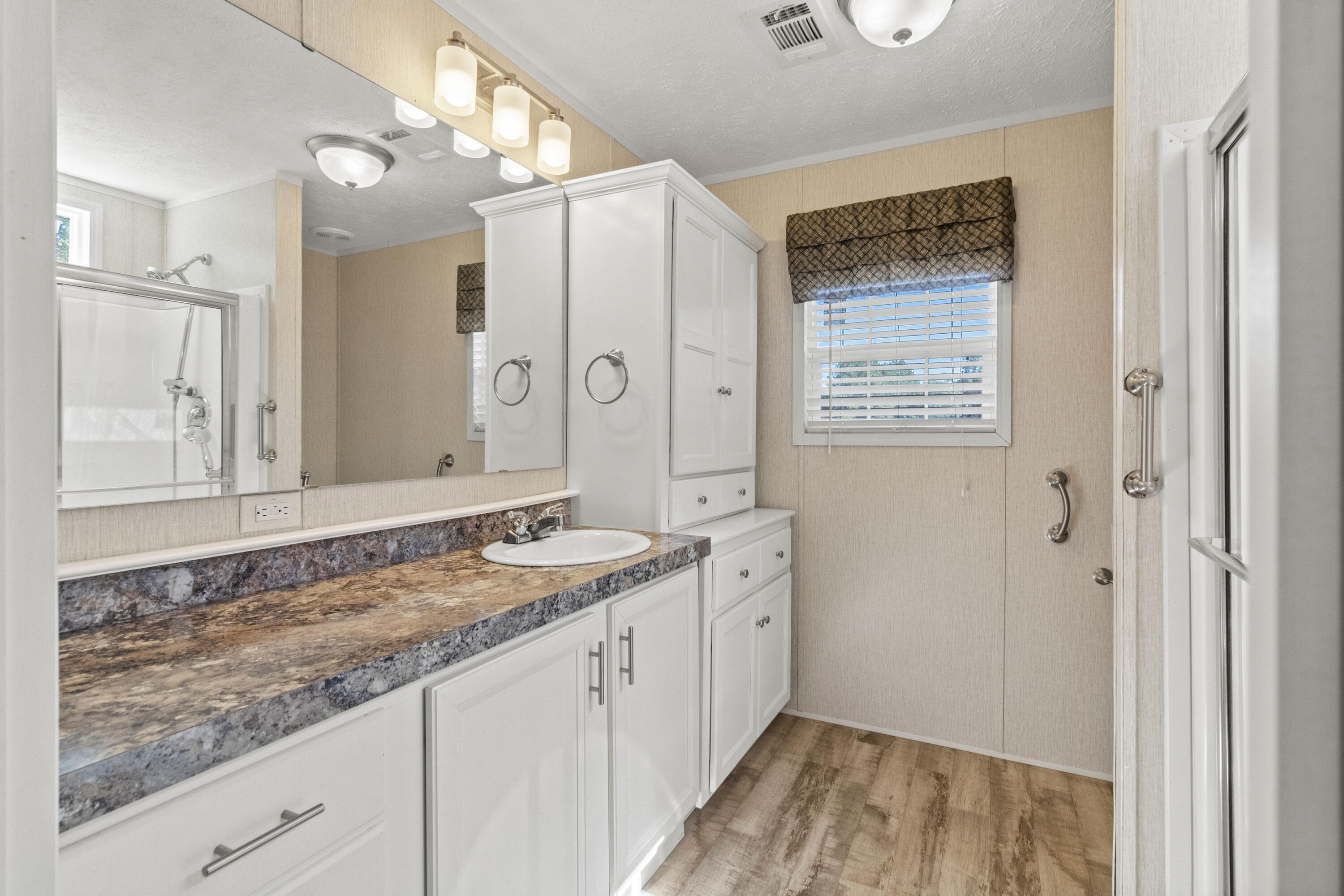 7419 Pappa Lawrence Road Laurel Hill, FL 32567 - Photo 26 of 40 a bathroom with a sink and a mirror