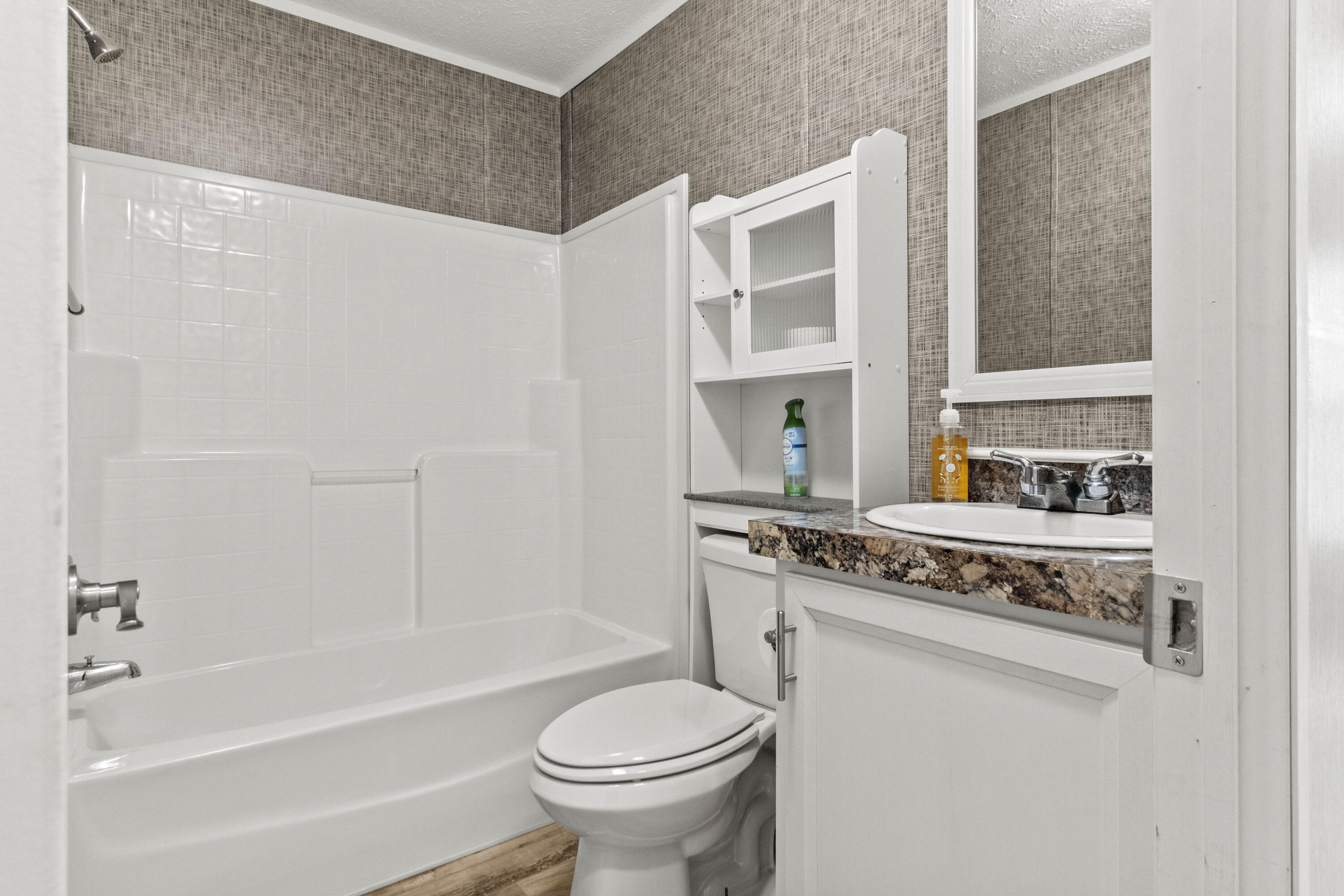 7419 Pappa Lawrence Road Laurel Hill, FL 32567 - Photo 29 of 40 a bathroom with a granite countertop toilet sink and mirror