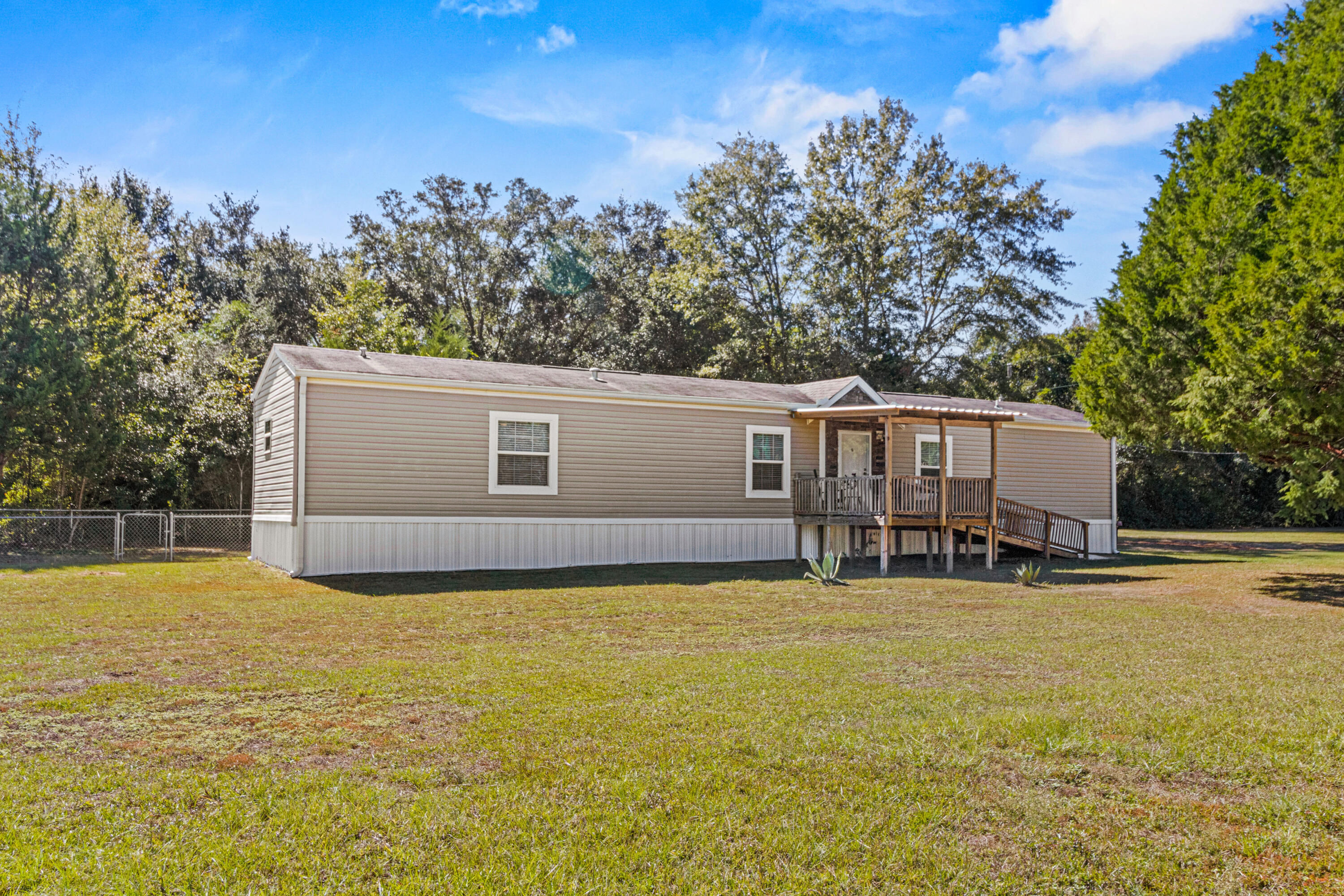 7419 Pappa Lawrence Road Laurel Hill, FL 32567 - Photo 3 of 40 a view of a house with yard and trees in the background