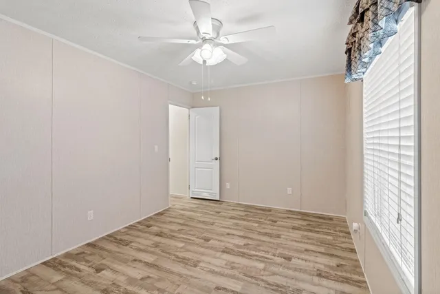 a view of deck and backyard with wooden fence