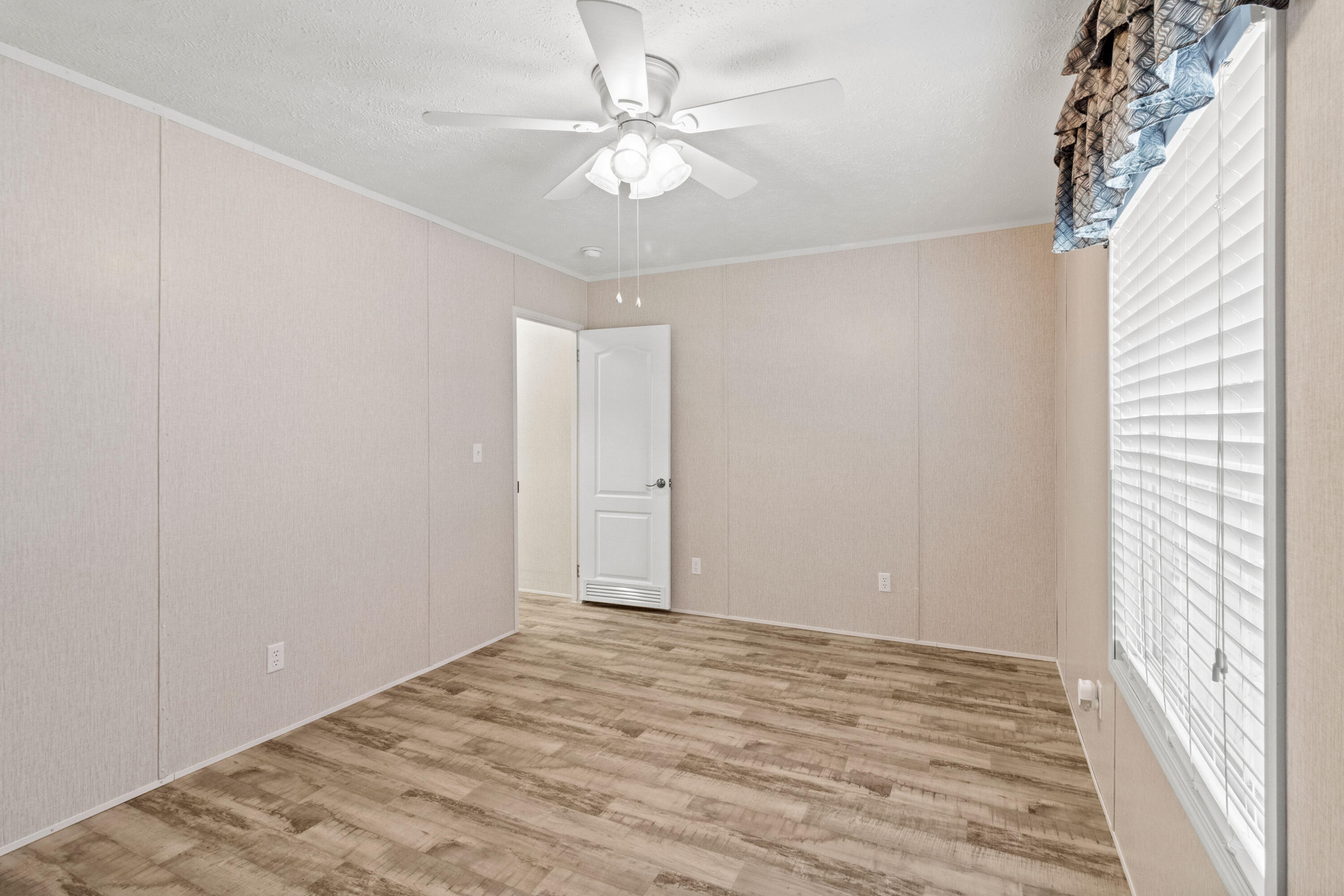 7419 Pappa Lawrence Road Laurel Hill, FL 32567 - Photo 31 of 40 wooden floor in an empty room with a window