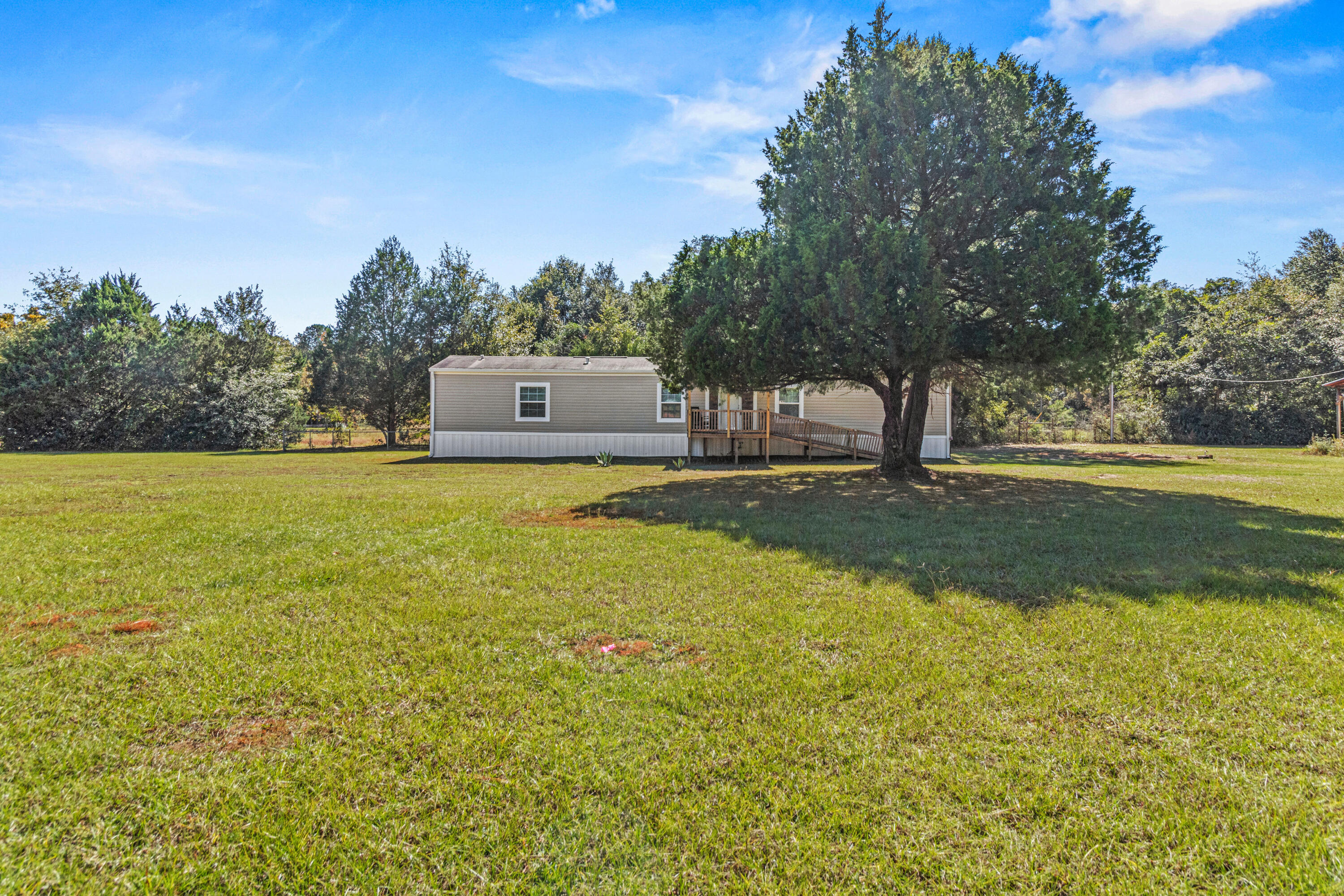 7419 Pappa Lawrence Road Laurel Hill, FL 32567 - Photo 34 of 40 a view of a lake with a house in the background