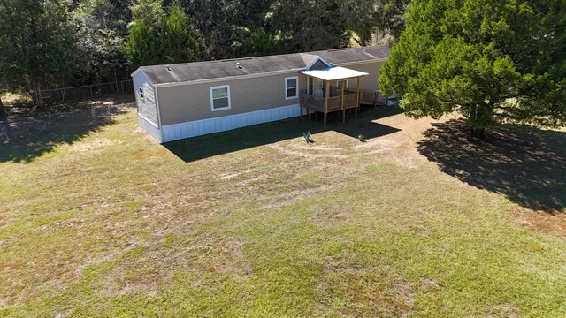 a view of front door of house with a yard