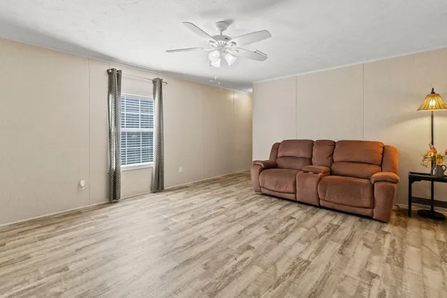 a room with a bed mirror and couch