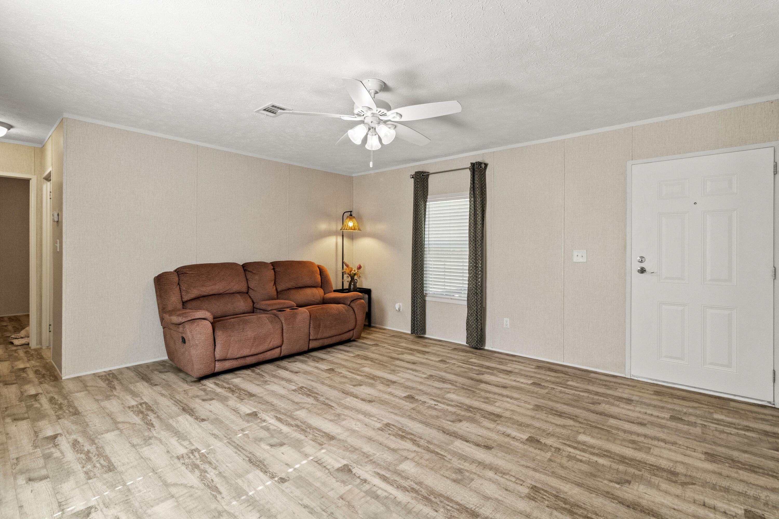 7419 Pappa Lawrence Road Laurel Hill, FL 32567 - Photo 10 of 40 a living room with furniture and a ceiling fan