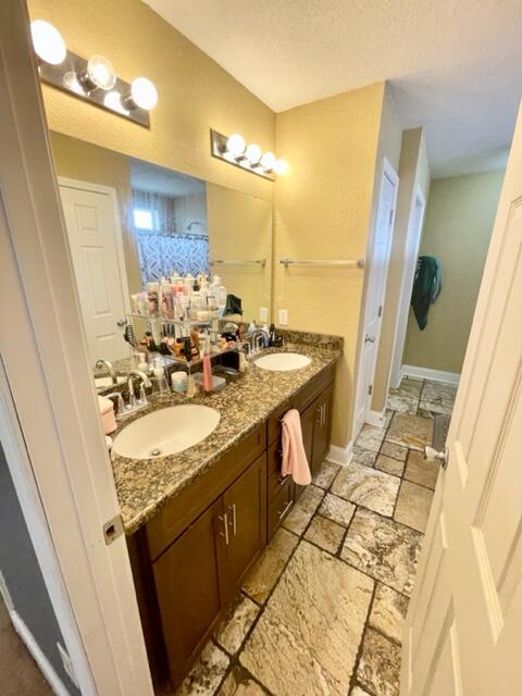 229 Limestone Circle Crestview, FL 32539 - Photo 10 of 22 a bathroom with a granite countertop sink and a mirror