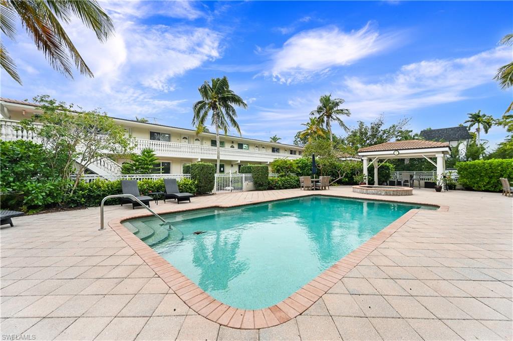 950 7th Avenue South, Unit 26 Naples, FL 34102 - Photo 12 of 15 a view of a swimming pool with a patio
