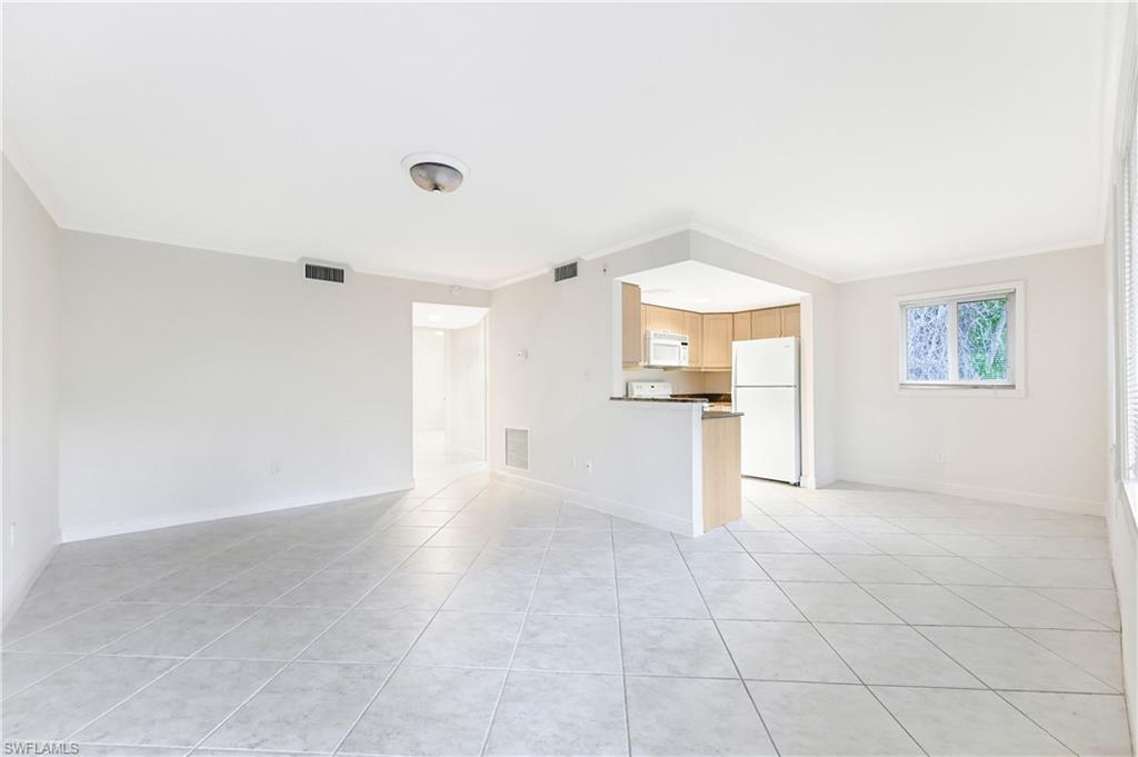 950 7th Avenue South, Unit 26 Naples, FL 34102 - Photo 2 of 15 a view of a kitchen with furniture and an empty room