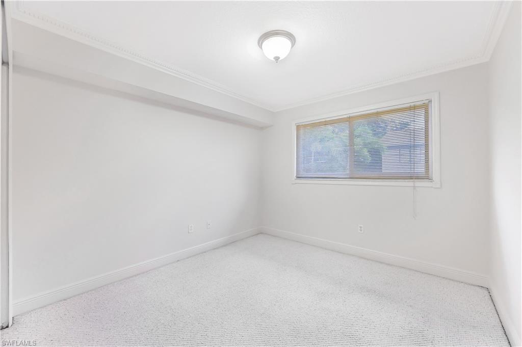 950 7th Avenue South, Unit 26 Naples, FL 34102 - Photo 6 of 15 a view of an empty room with a window