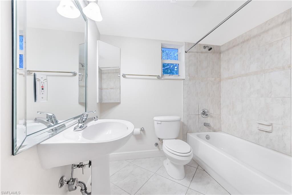 950 7th Avenue South, Unit 26 Naples, FL 34102 - Photo 8 of 15 a bathroom with a toilet sink shower and bathtub