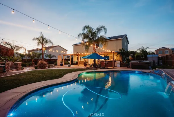an aerial view of a house with swimming pool and outdoor space