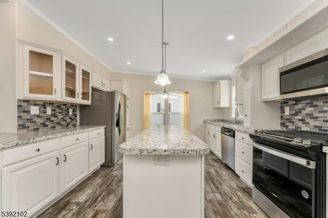 a kitchen with a sink stove and microwave