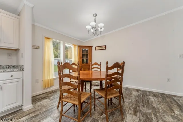 a view of a dining room with furniture and chandelier