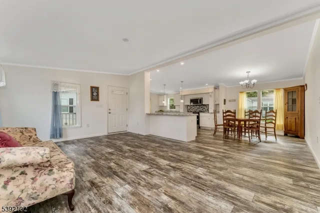 a living room with furniture and kitchen view