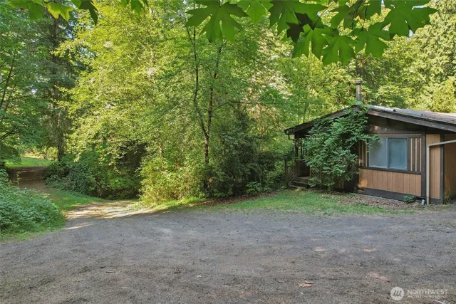 a view of a house with large trees