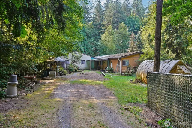 a view of a house with backyard and sitting area