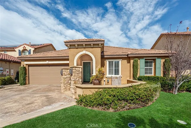 a front view of a house with garden