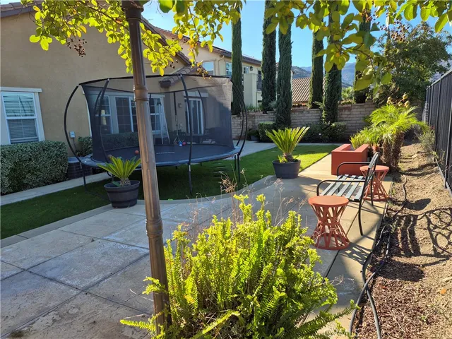 a view of a chair and table in the garden