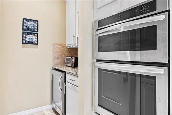 a kitchen with cabinets and stainless steel appliances