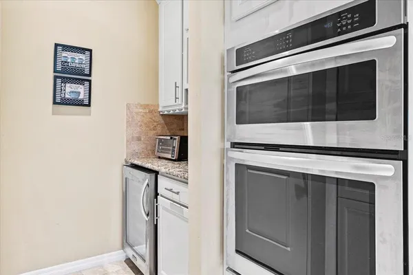 a kitchen with cabinets and stainless steel appliances