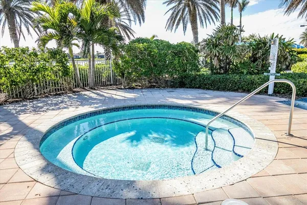 a swimming pool with outdoor seating and plants