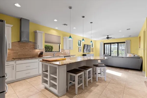 a kitchen with kitchen island stainless steel appliances a sink and counter space